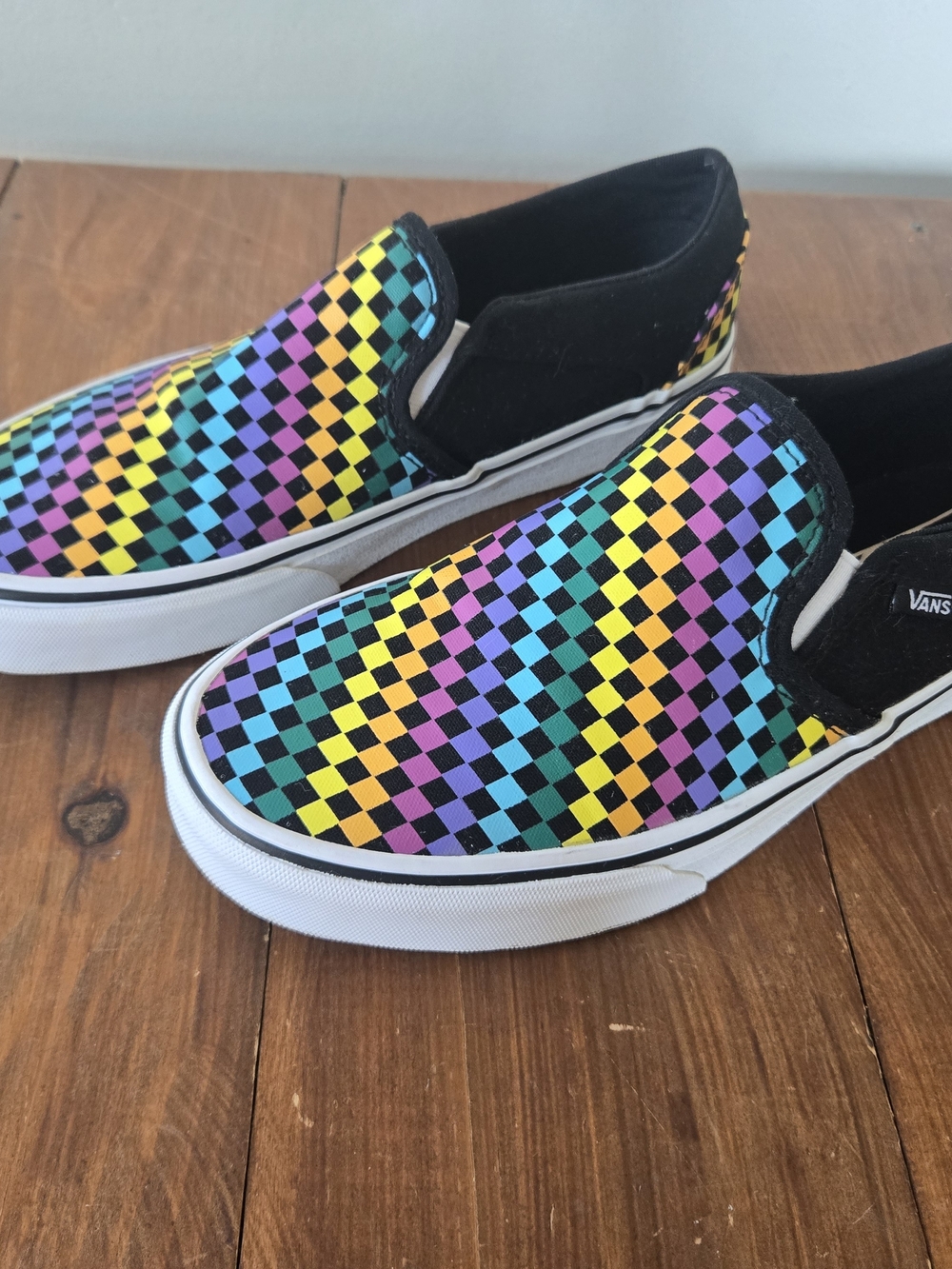 Vans Slip-On Sneakers in Rainbow Checkerboard and Black